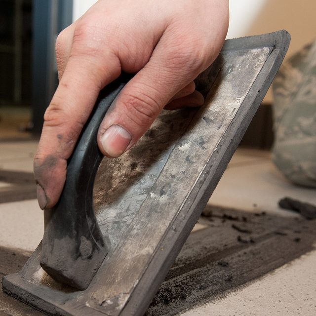 Grout being filled into tile joints