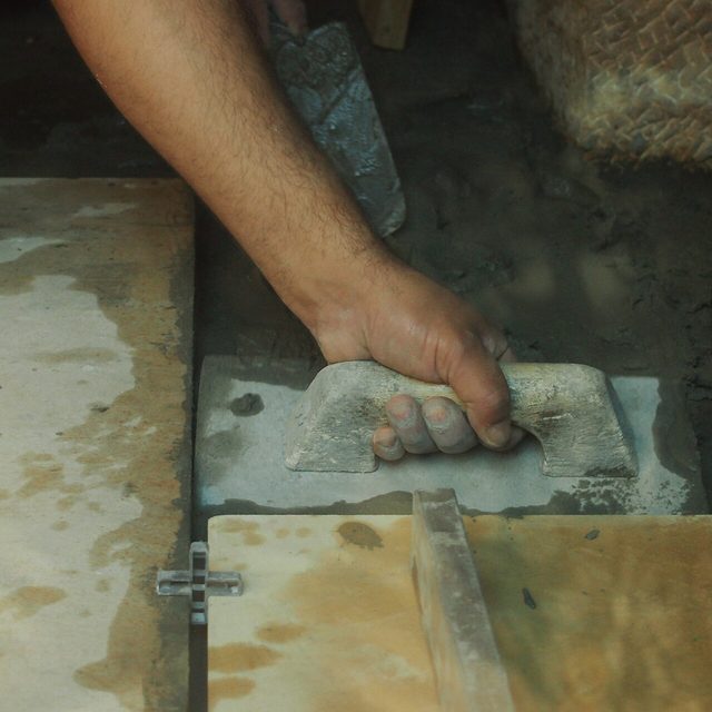 Tile adhesive spread with a notched trowel